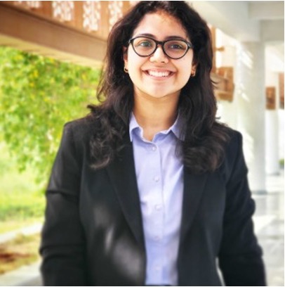 Portrait photo of Qutbuddin Habib, male with short hair, wearing a dark blazer and shirt, looking confident with folded arms